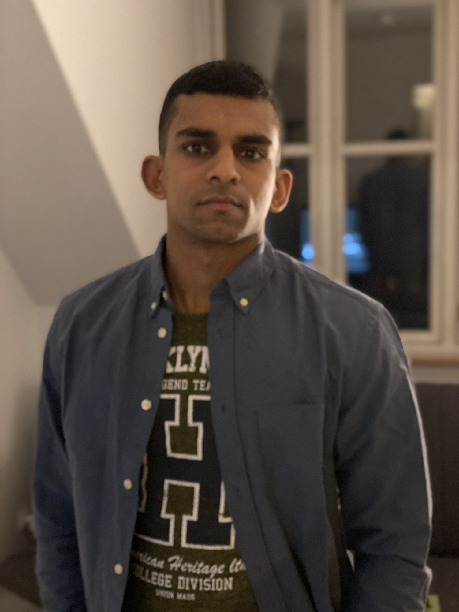 Gin in a blue shirt, looking serious, 2020