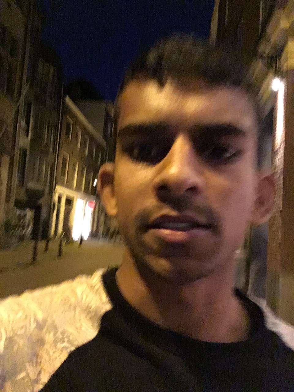 Gin alone on an empty street at night